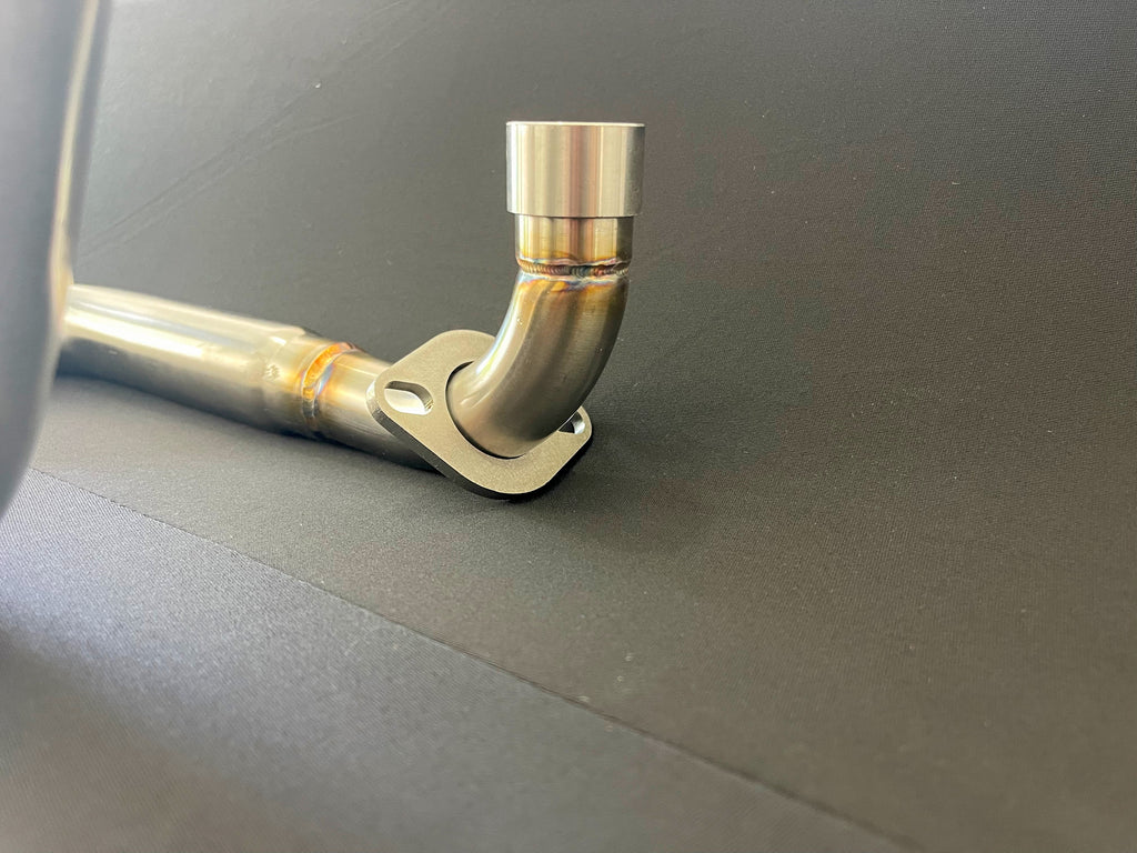 Honda Monkey with Stealth x Kruesi Originals exhaust system – rear angle showing stainless muffler