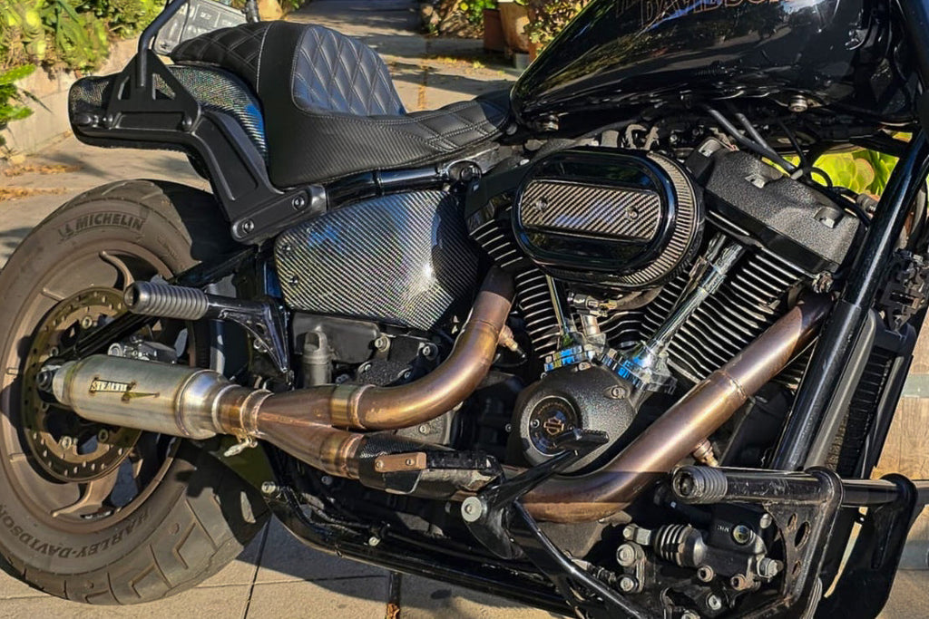 Stealth Pipes exhaust system installed on Harley M8 Softail – rear-side view of muffler and headers (2017–2025)